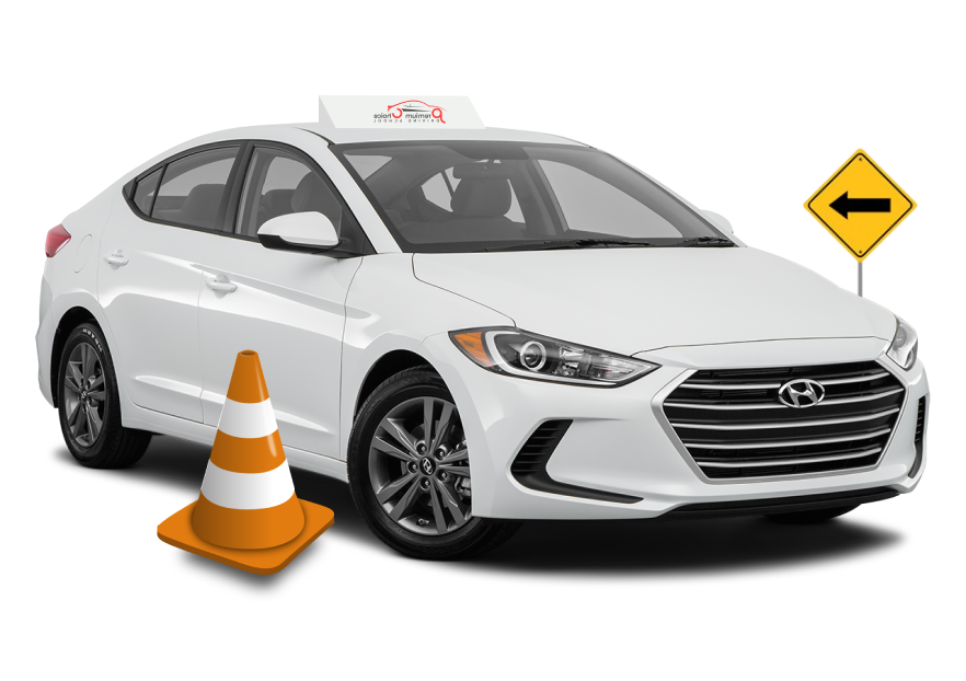 White car with driving school roof sign, traffic cone, and right turn arrow sign.